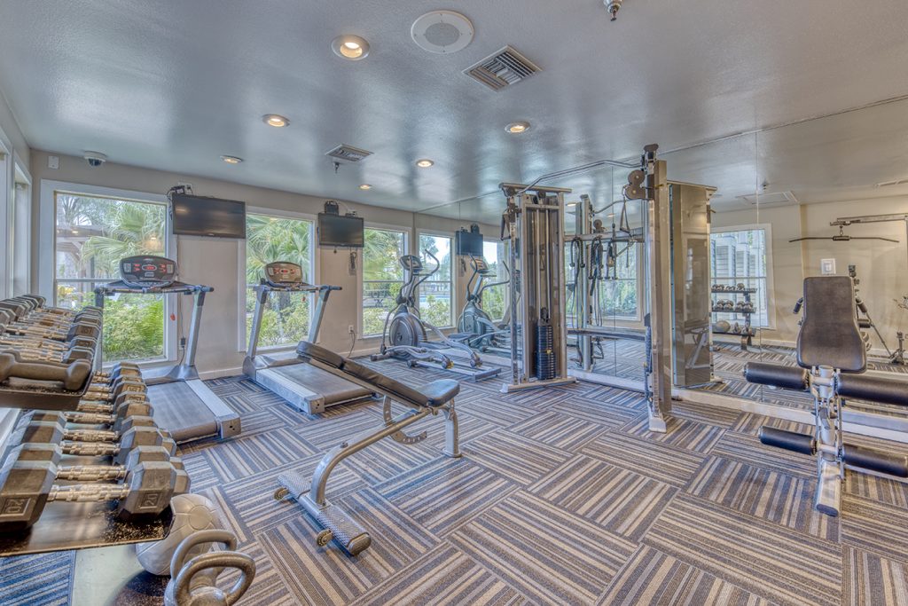 24-hour fitness center with cardio and weight equipment